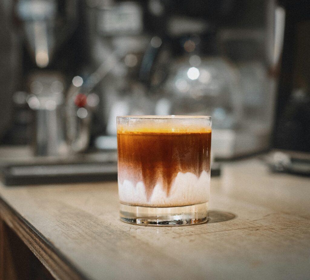 A glass of iced coffee on a rustic café counter in Tokyo, Japan.