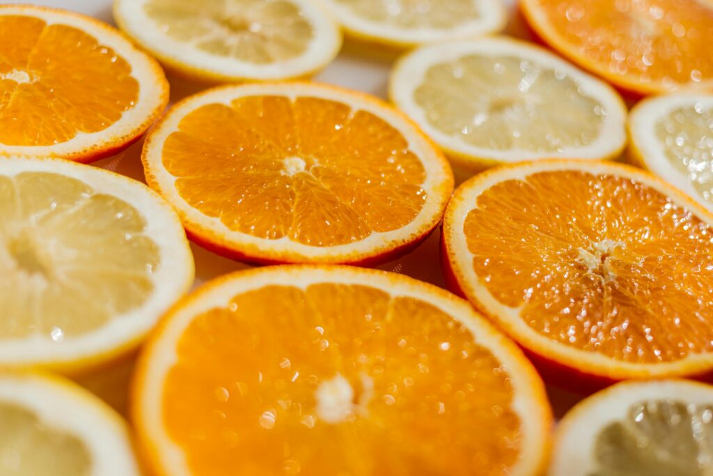 Vibrant close-up of fresh sliced oranges and lemons on display, perfect for promoting health and freshness.